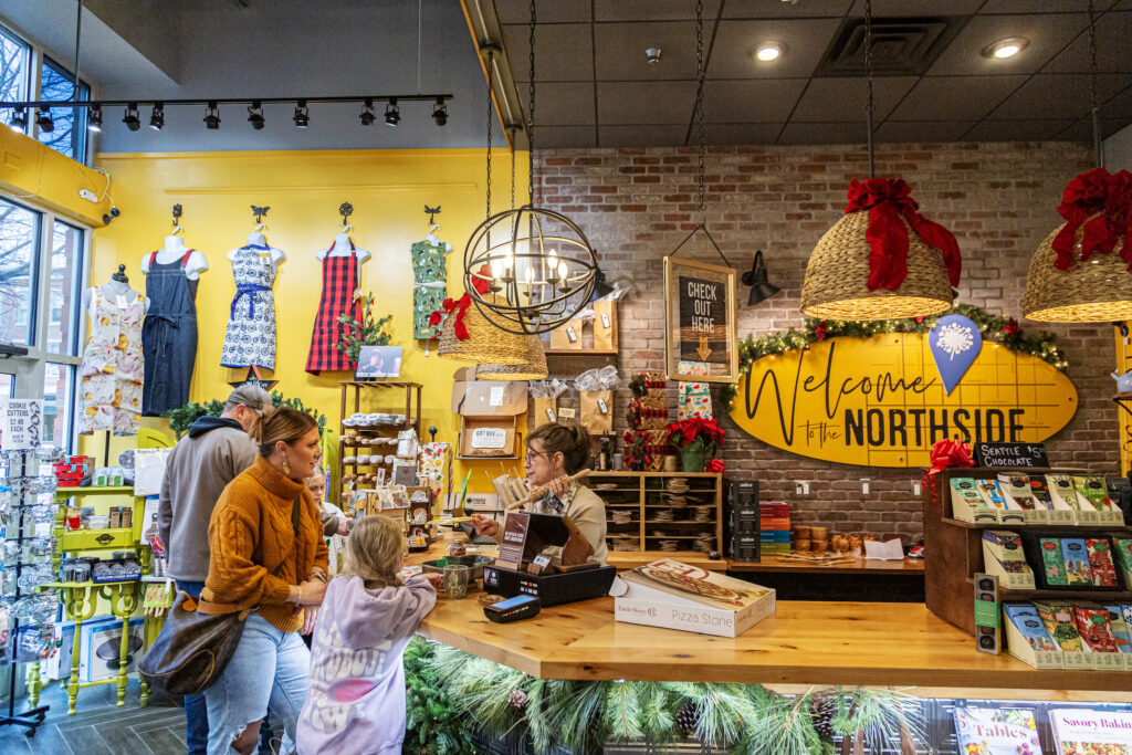 Shoppers standing at a counter near a store clerk at a Downtown Iowa City Business.